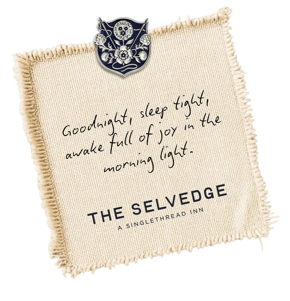 The Selvedge embroidered hospitality patch featuring a handwritten welcome message and floral crest.