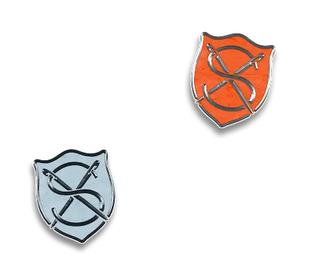 Two enamel crest pins featuring The Selvedge monogram in blue and orange colorways.